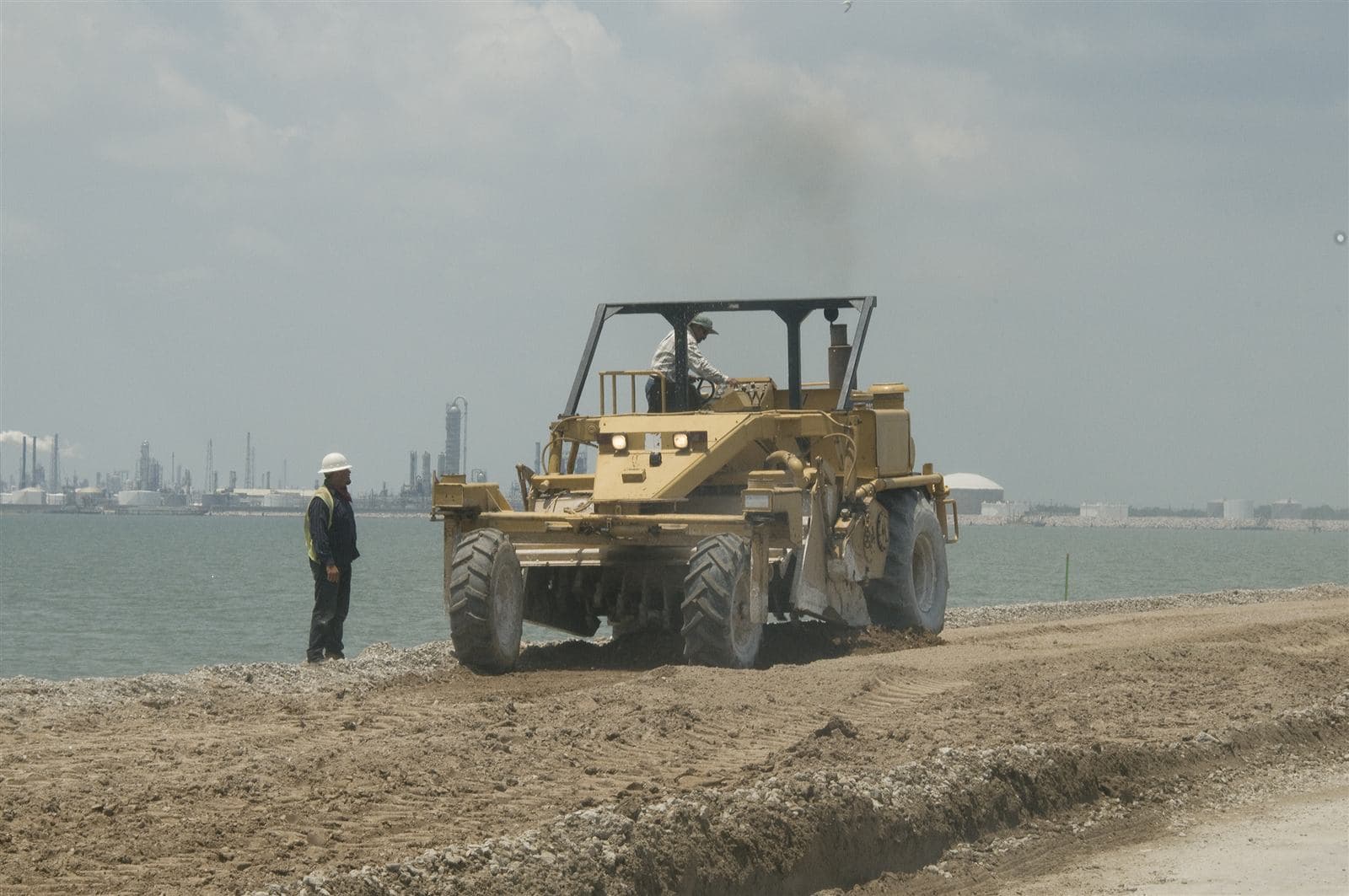 Road repair crew resurfacing the damaged road