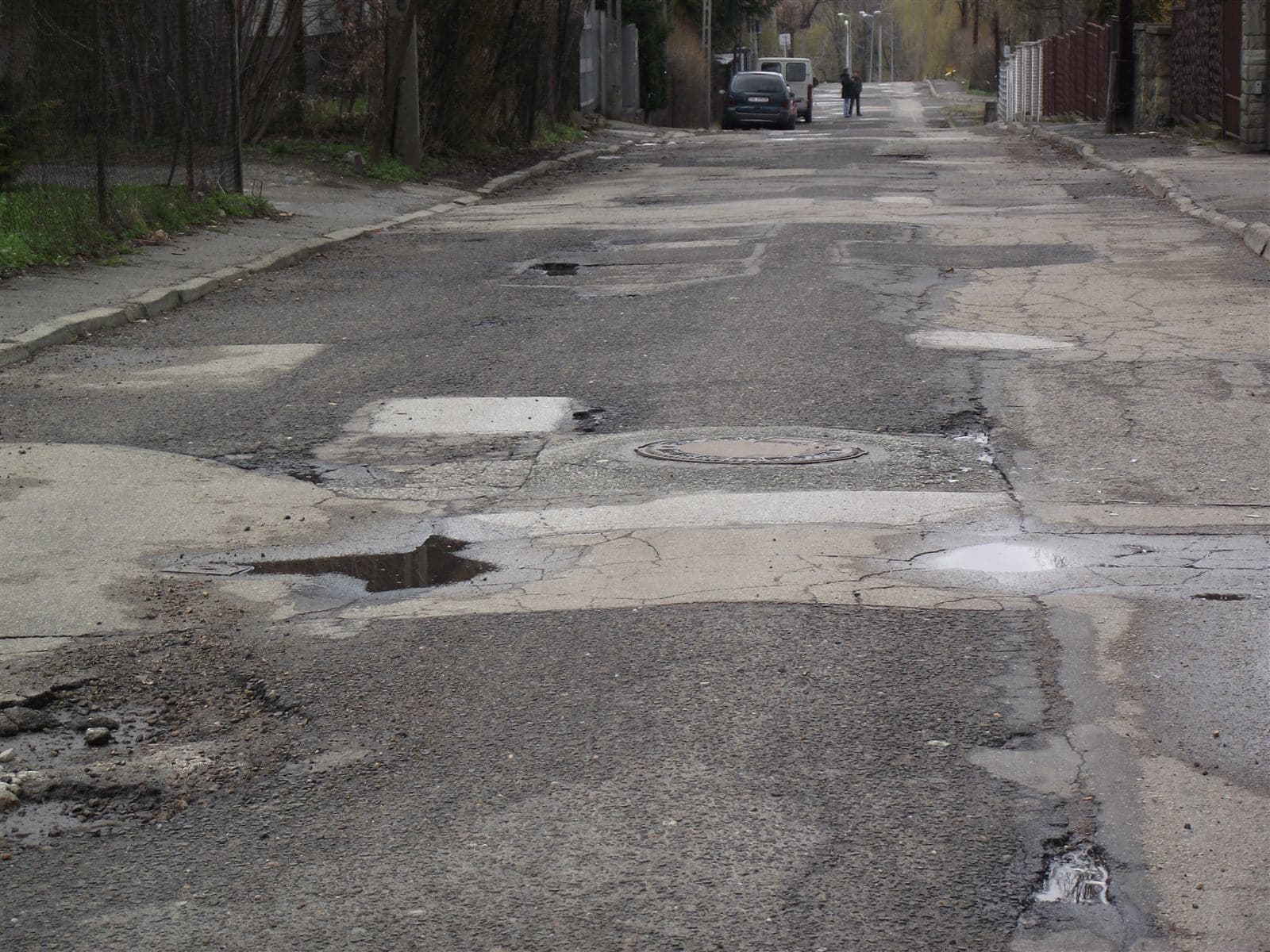 Large pothole in a damaged road on MG Road, the civic issue this AI analysis describes